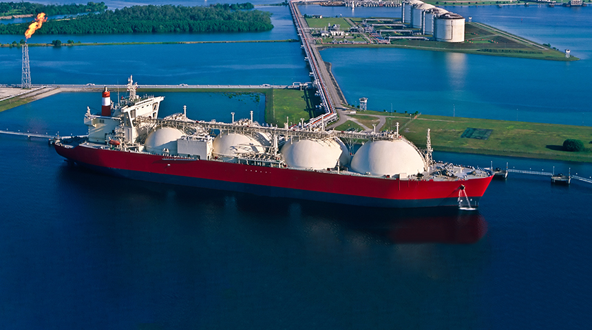 Natural gas tanker at port with LNG liquefaction plant